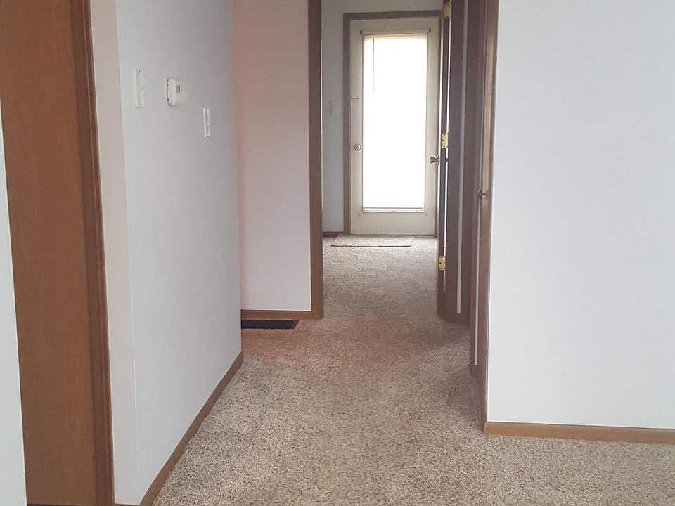 Entering front door. Kitchen to the left. Living room to the right. Bath to the left down the hall. Storage, bedroom 1 on the right and bedroom 2 straight ahead