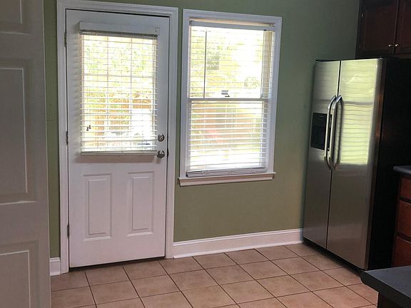 Kitchen door that opens on a beautiful green space.
