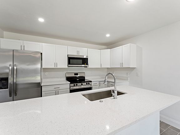 Fully upgraded kitchen with stainless steel appliances and spacious island.