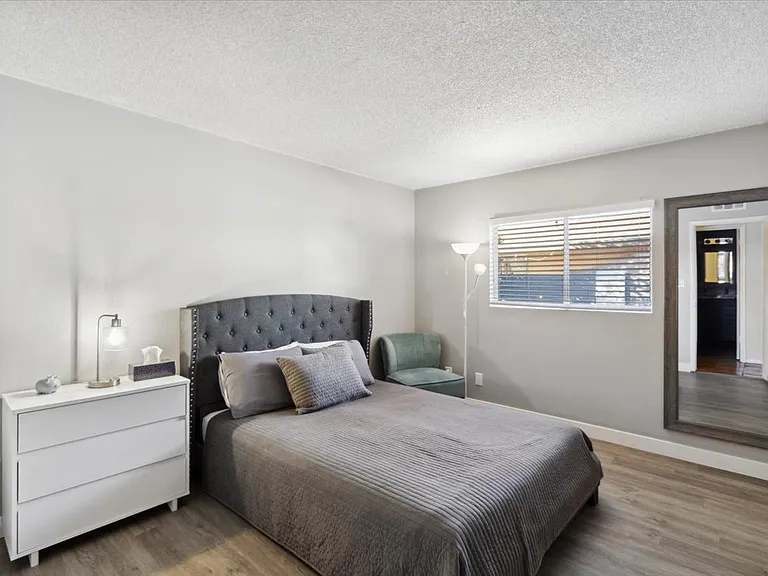 Bedroom 3: Queen sized bed, dresser, and extra seating