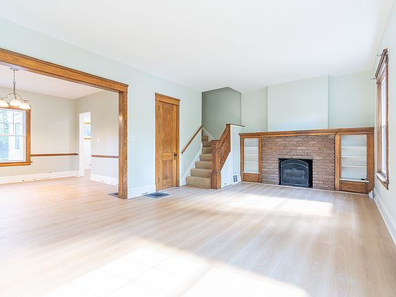 New wood floors throughout first floor. Open concept floor plan between living room and dining room for a more spacious feel.