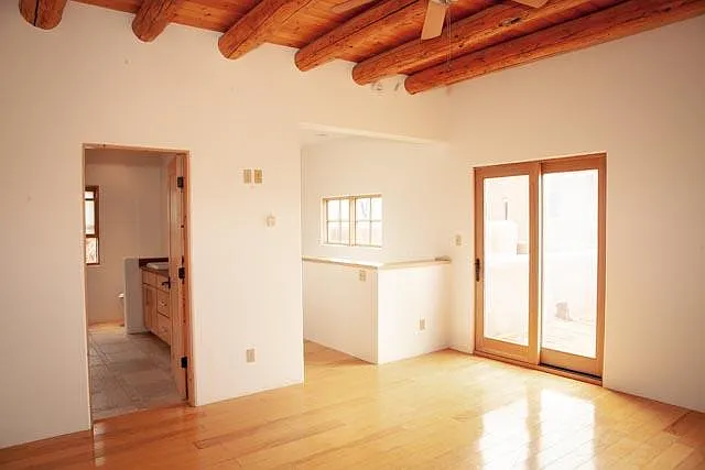 Very private, bright and sunny second-floor master features tall viga ceilings for a spacious, airy feel. Large lux master bath to left, plus large sunny view deck through sliding doors on right.