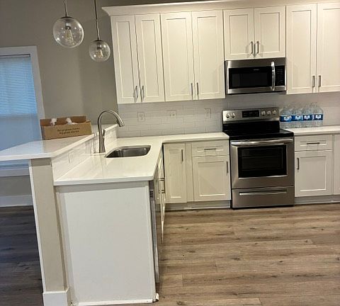 Kitchen with dishwasher, microwave, oven and refrigerator
Shaker style Cabinets