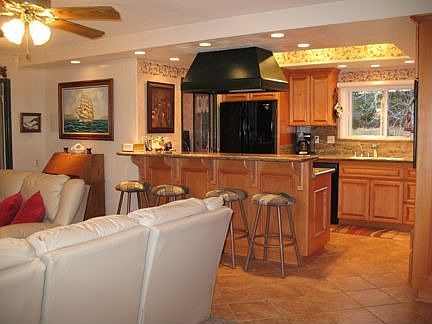 Open family kitchen with granite counters, 5 burner cook top, maple cabinetry