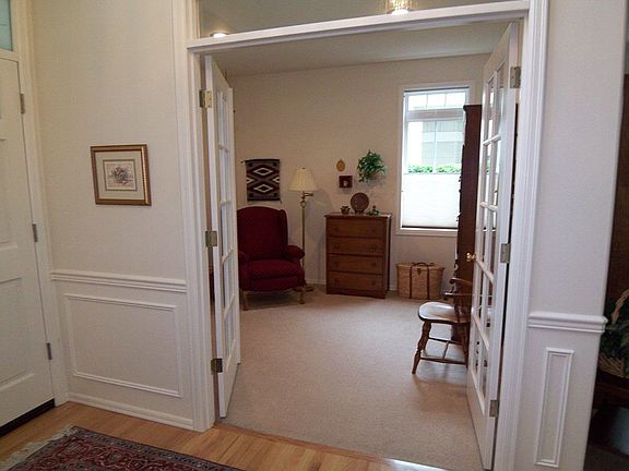 Glass paneled French Doors open from the entry to the den or parlor.