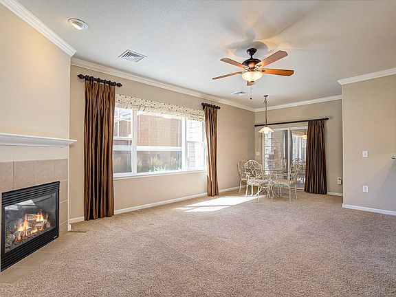Bright, open concept living room with a cozy fireplace.