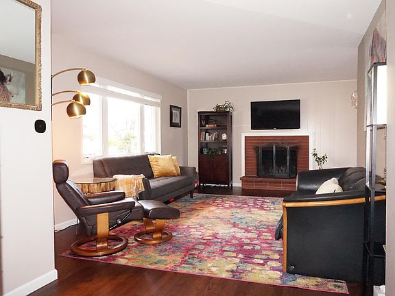 Working wood fireplace in open living room.