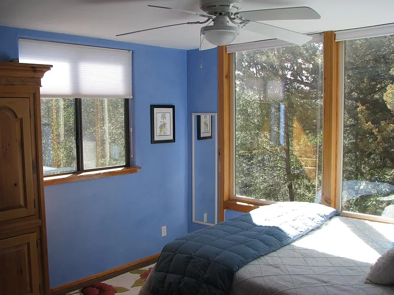 The bedroom with large picture windows