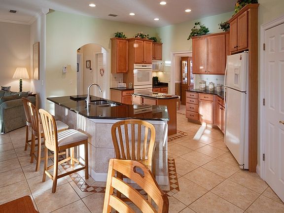 dark granite featured kitchen with breakfast bar and separate eating area