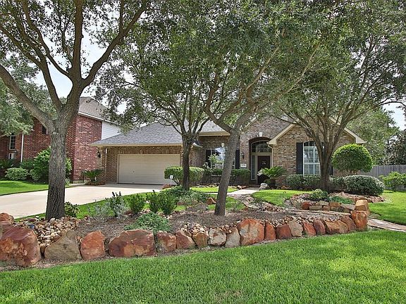 Sit on the front covered porch and enjoy the upgraded landscaping package with mature trees.