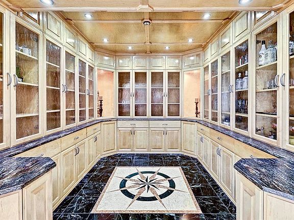 Trophy Room w/ custom built-in cabinetry & marble designed floor