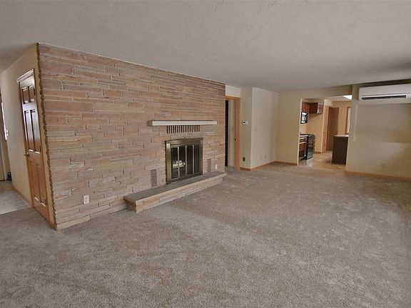 Sunlit Living Room W/ Wood Burning Fireplace