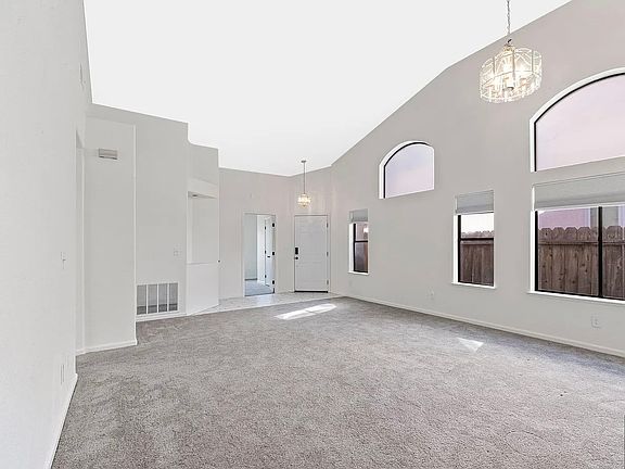 Soaring ceilings enhance the bright, open living room.