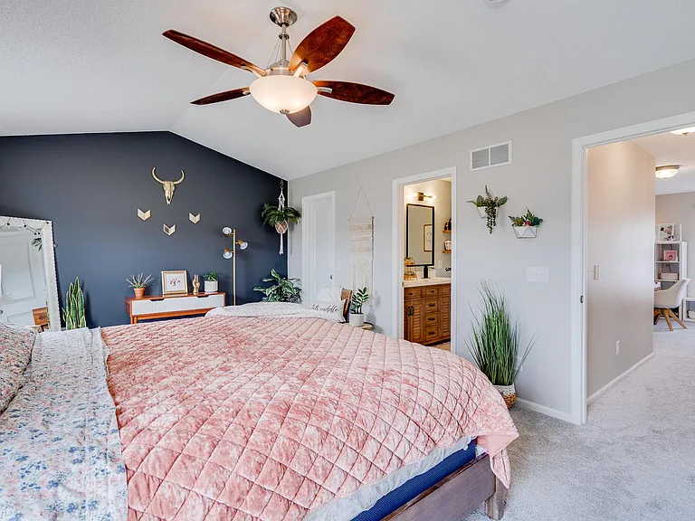 upper floor - large master suite bedroom looking out at the loft area down the hall and upstairs bathroom.