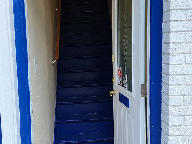 The entrance to the apartment shows a reflection of the County courthouse across the street.