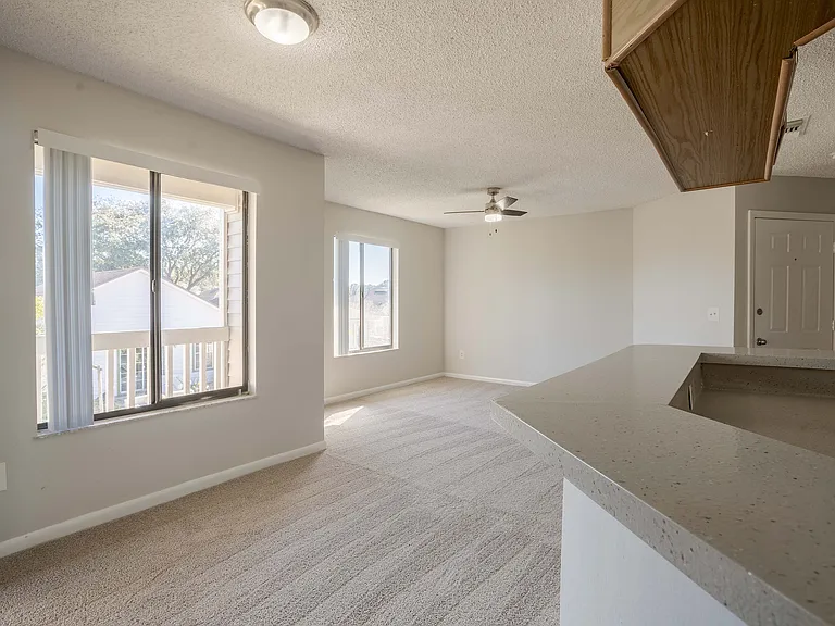 Embrace the sunlight in this spacious, open-plan living area.