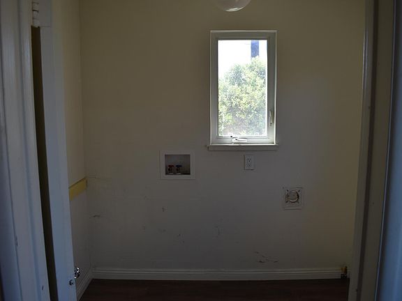 Laundry room inside house. adacent kitchen access to powder room bathroom. with access to back yard.