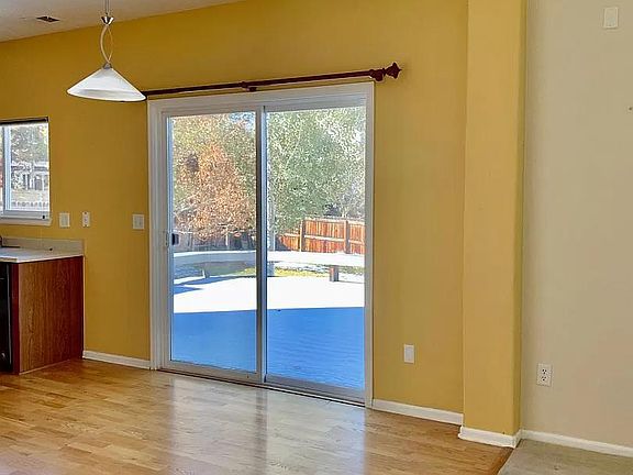 The dining area opens onto a large composite deck surrounded by a low maintenance yard and mature trees for shade and privacy