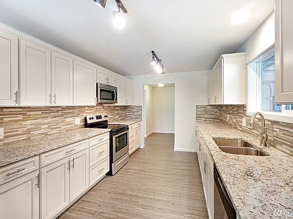 You will literally Fall in Love with this gorgeous kitchen. Granite slab countertops with glass tiled backsplash. Stainless steel appliances, cabinets, drawers and storage galore!