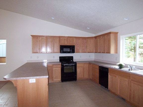 Large kitchen with window over sink and bar