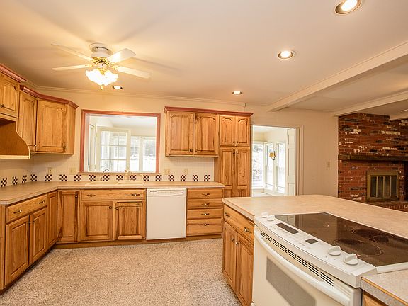 White appliances include dishwasher and flush-mount electric range.