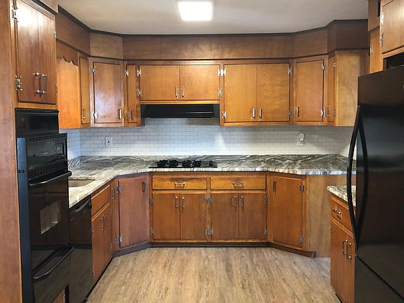 Spacious kitchen with new granite countertops, fresh backsplash, and laminate floors!
