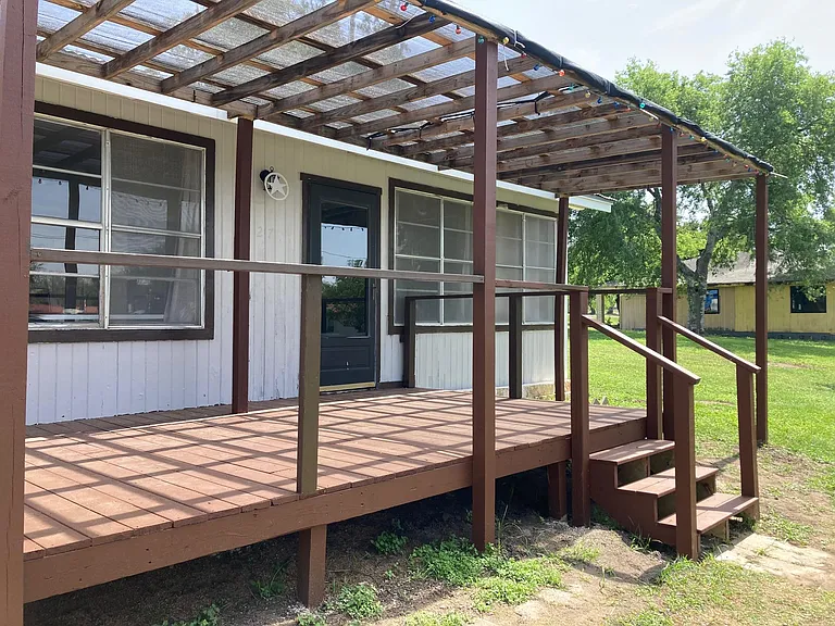 deck and steps leading to front entrance
