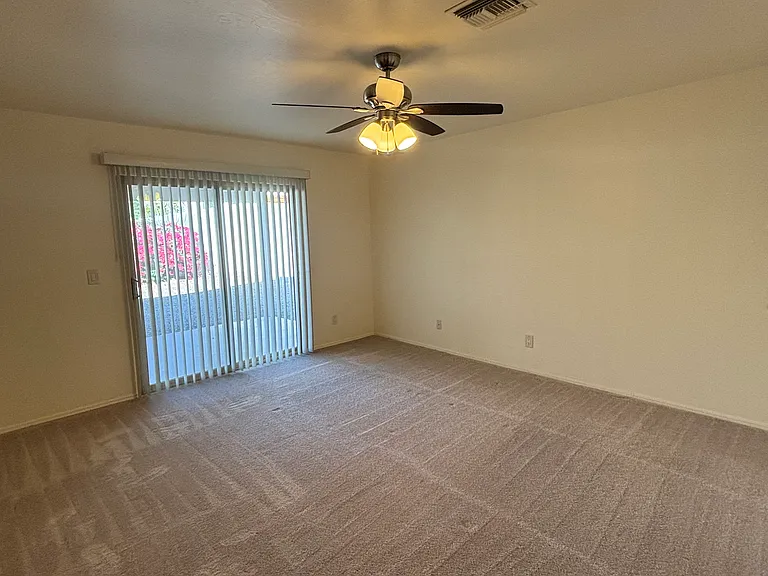 Primary bedroom opens to backyard patio