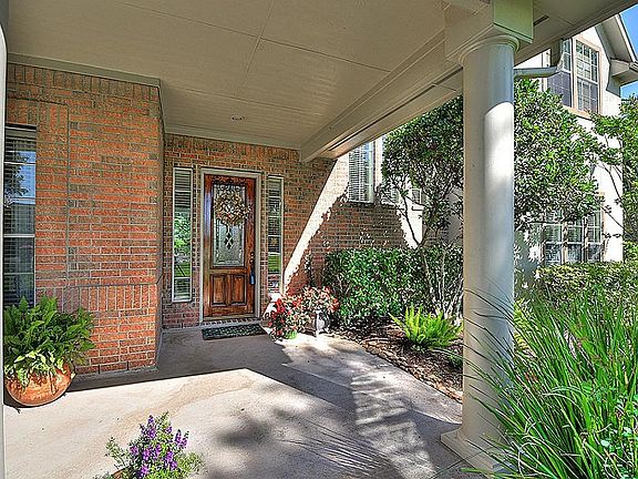Large, yet cozy front porch. Note the 8  front door with leaded glass and side light windows.