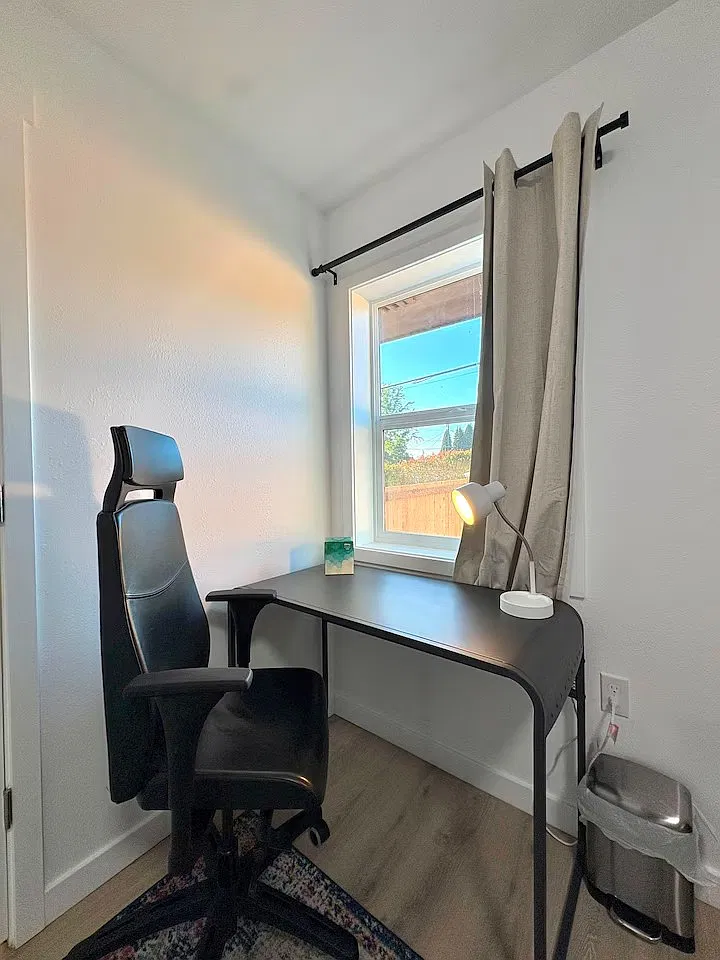 (Private Bedroom Workspace) Comfortable workspace with a desk and chair for remote work or study.