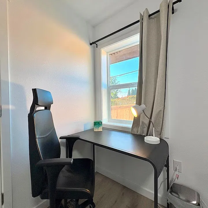 (Private Bedroom Workspace) Comfortable workspace with a desk and chair for remote work or study.