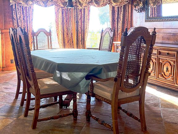 Formal wood-panel dining room, with slate-tile floor. Optional dining table and chairs with Hutch are provided or can be removed at the renter's discretion.