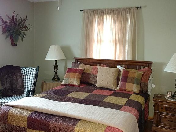 Bedroom with hardwood floors and full closet