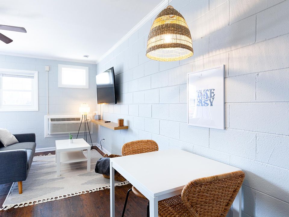 Open layout between living room, dining area, & kitchen