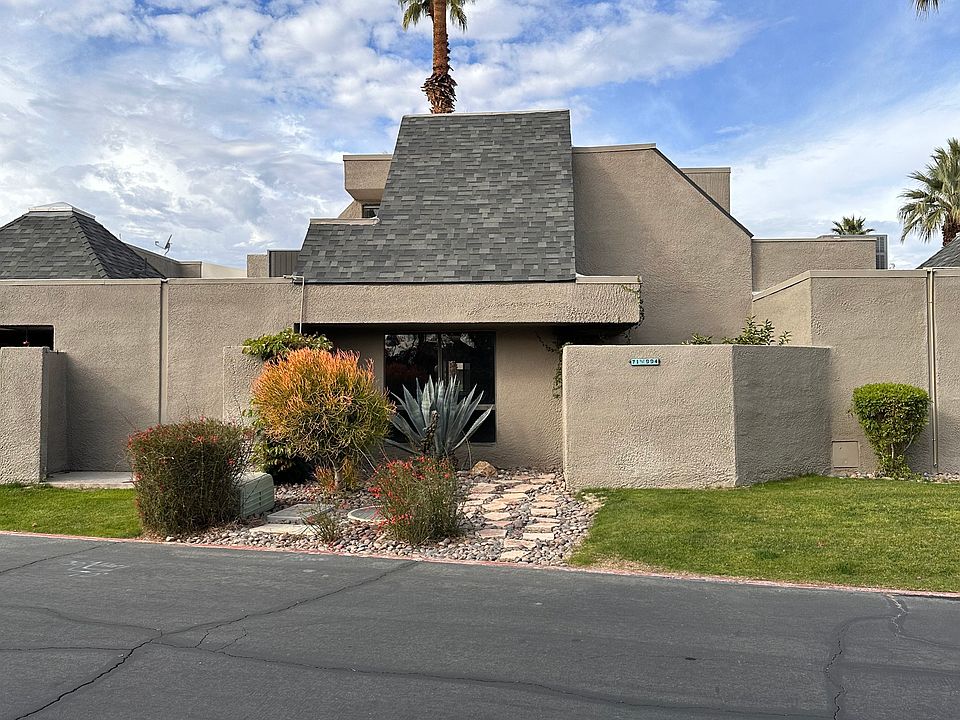 Private patio/backyard entrance surrounded by desert landscaping.