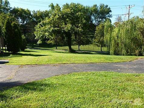 52' x 150' Near Level Yard.  Spelled out in the Deed Driveway can be Accessible to Military Parkway.  Garage is Built in.