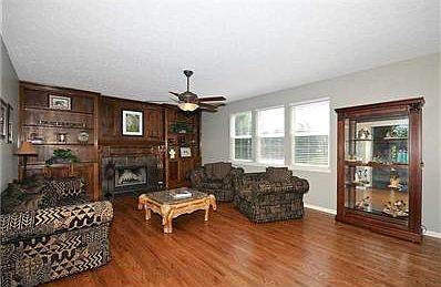 Great Room. Custom built-ins with wood burning fireplace.