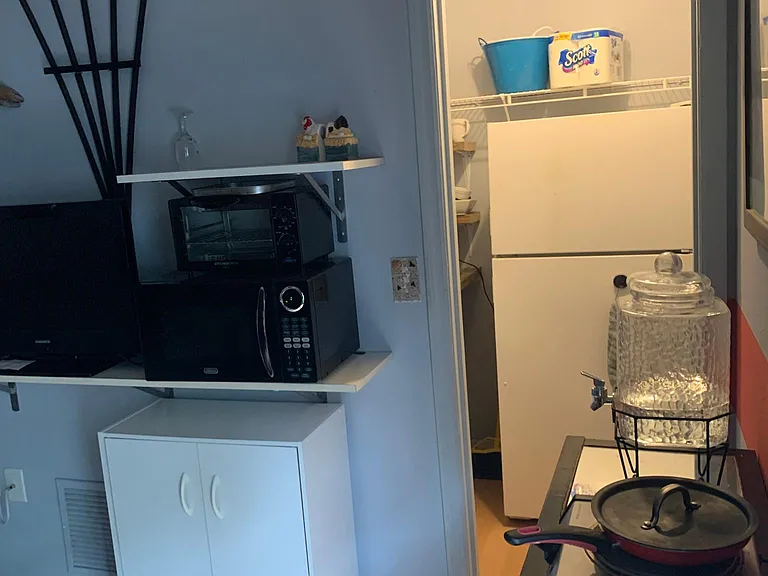 From the sitting room: there's the fridge nook. The sink is in there, too.