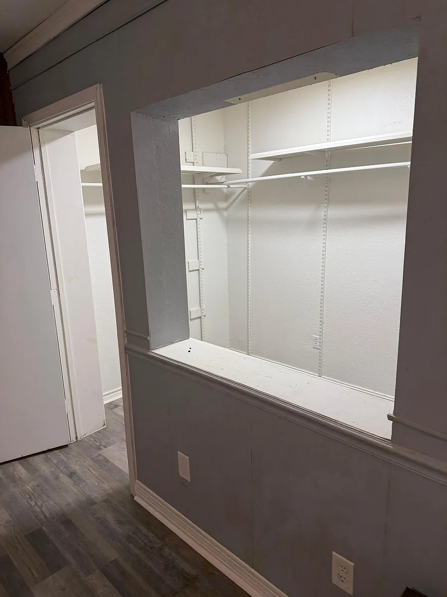 Photo 2 of 5 - Hackberry St - Lancaster, TX Built-in closet nook with adjustable shelving and hanging rods provides convenient storage off the main hallway. - Hackberry St