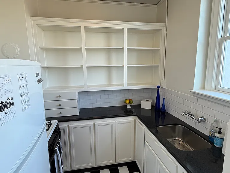 Black & white kitchen, fresh new flooring, granite counter, deep sink, gas stove/oven, full fridge/freezer, and a view while you are at the sink (new pull-down black faucet on the way, being installed asap).