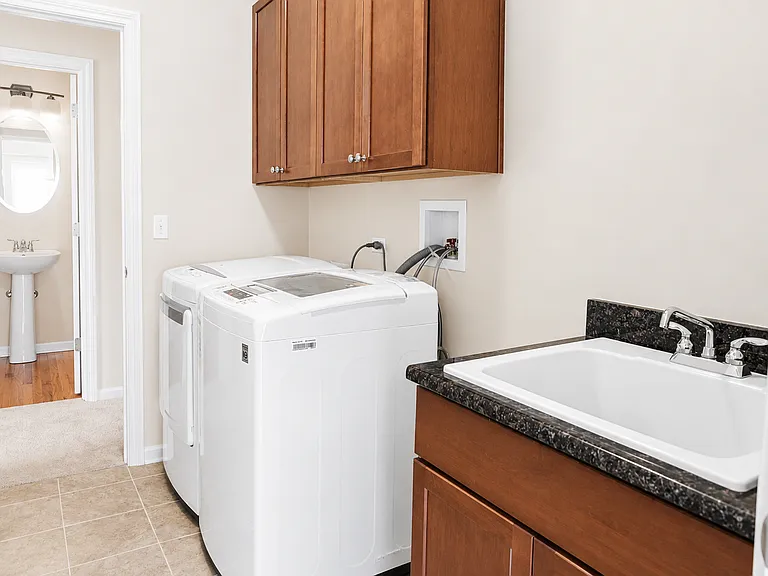 Laundry area with a view toward the powder room.