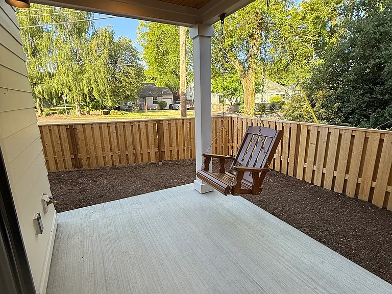 Backyard space with porch swing and overhead fan!