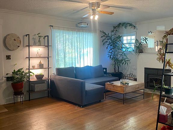 The cozy living room features a projector, creating the perfect atmosphere for movie nights.