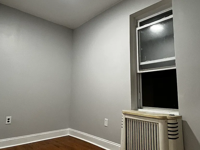 Third room with new laminate floors and recessed lighting