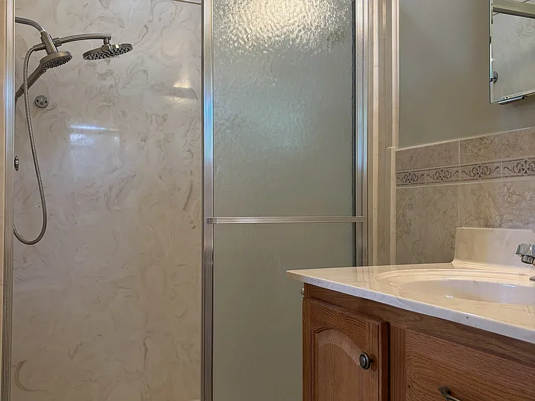 Secondary bedroom with its own private full bathroom, offering added comfort and convenience for guests or family members.