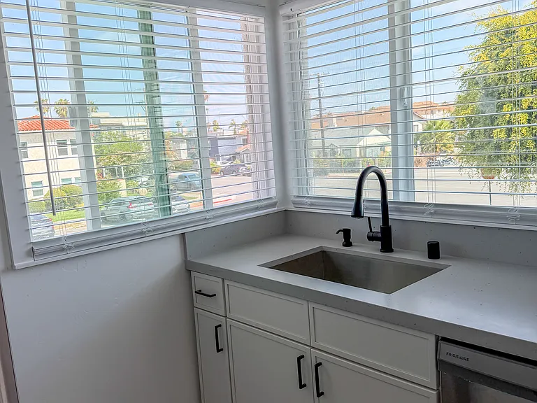 Whether you're washing dishes or prepping dinner, the abundant natural light and stunning backdrop turn this functional space into a peaceful retreat, making time spent in the heart of the home feel entirely effortless.