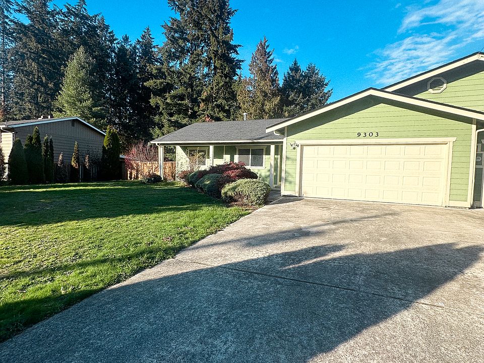 Front view of the duplex with ample parking and private fenced yard.