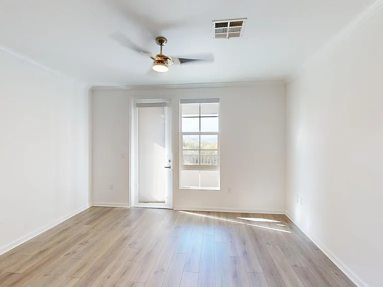 Apartment living room with wood style floor and balcony.