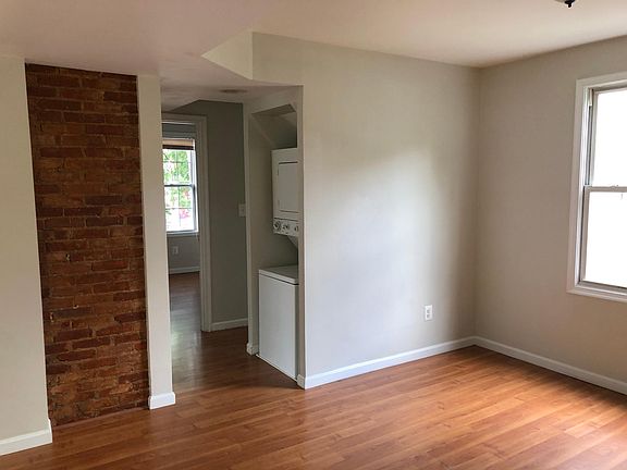 Other side of living room showing Washer/Dryer and one bedroom