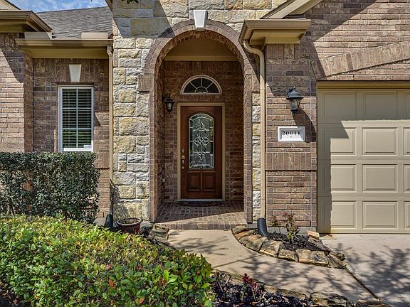Lush landscaping greets you as you walk up to the beautiful front glass leaded door.
